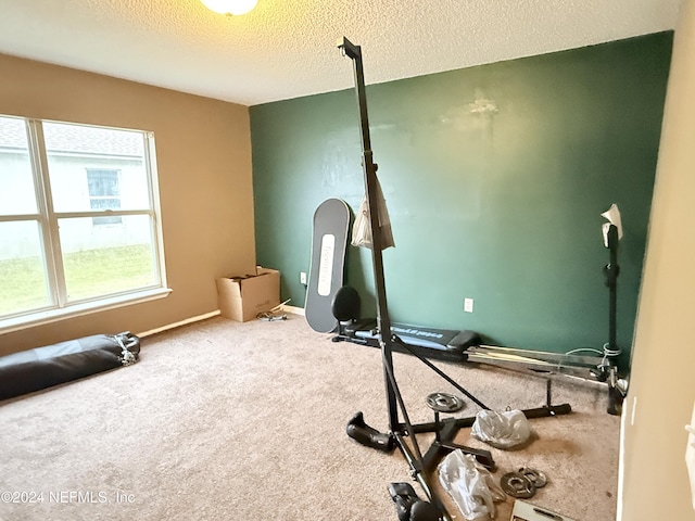 workout room with carpet floors and a textured ceiling