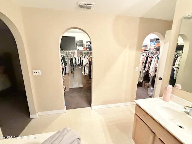 bathroom with tile patterned floors and vanity