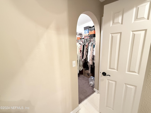 spacious closet with light tile patterned floors