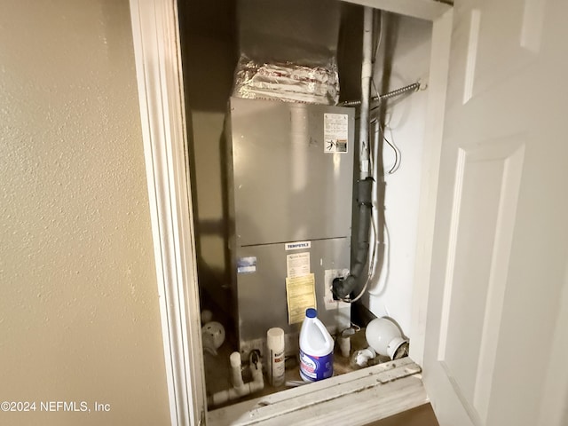 utility room featuring heating unit