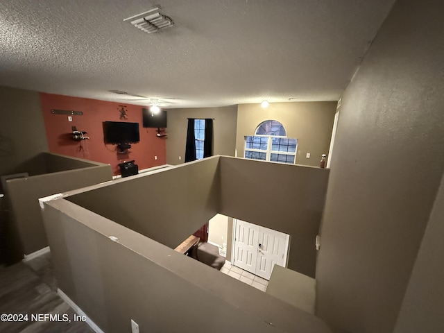 staircase with a textured ceiling