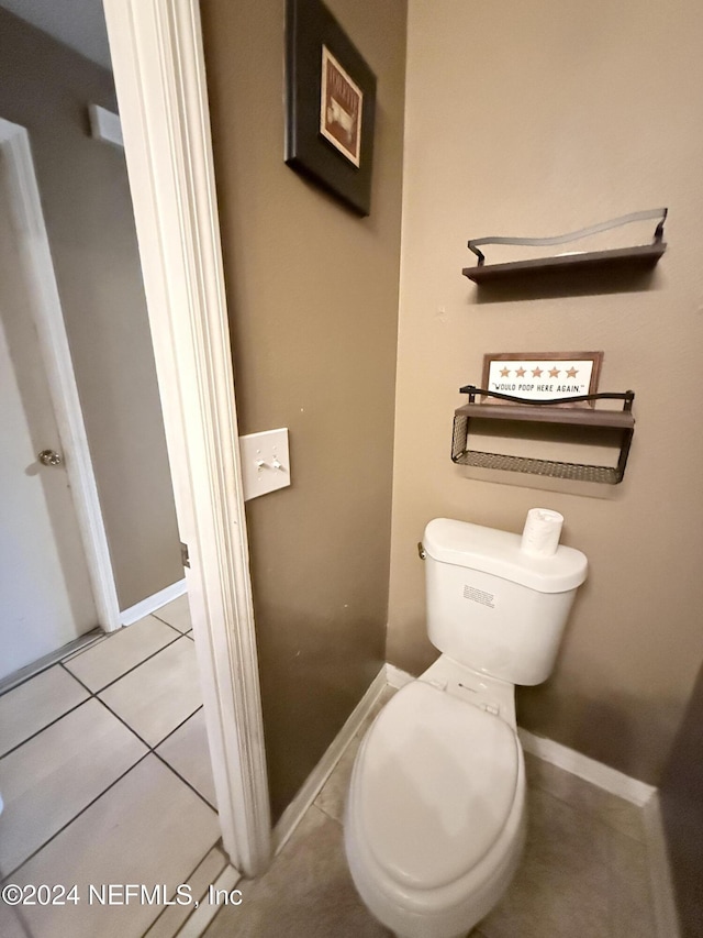 bathroom with tile patterned flooring and toilet