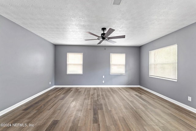 spare room with wood-type flooring, a textured ceiling, and ceiling fan