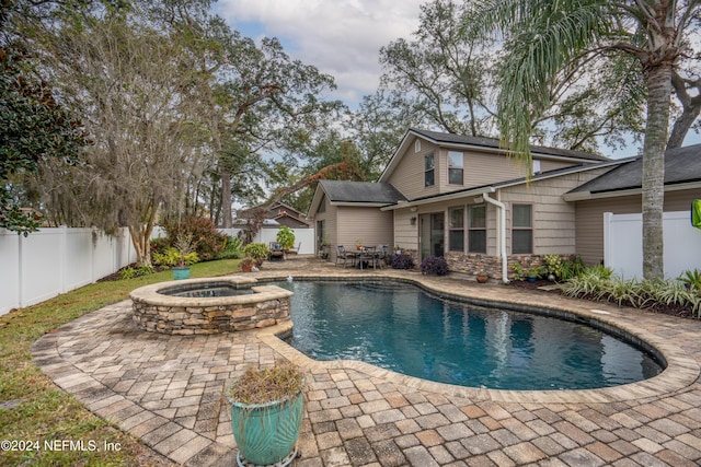 view of swimming pool with an in ground hot tub and a patio