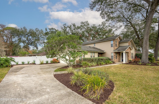 view of front of house with a garage and a front lawn