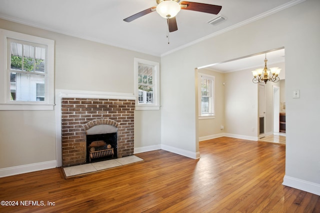 unfurnished living room with plenty of natural light, ornamental molding, and light wood-type flooring