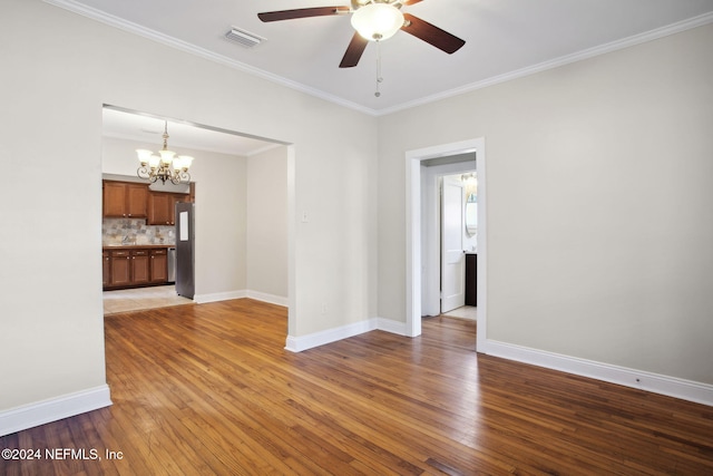 unfurnished room with crown molding, ceiling fan with notable chandelier, and hardwood / wood-style flooring