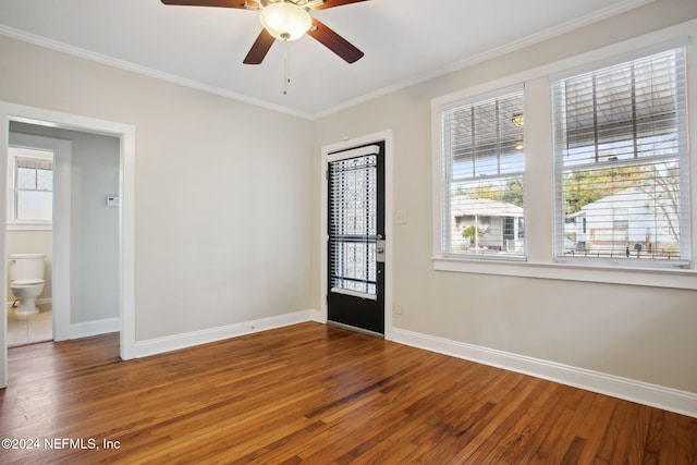 empty room with wood-type flooring, ceiling fan, and crown molding