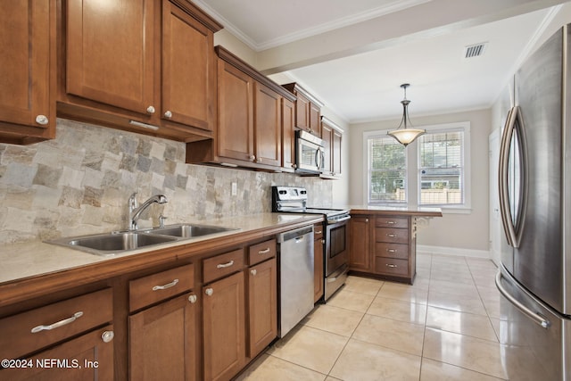 kitchen with sink, hanging light fixtures, backsplash, appliances with stainless steel finishes, and ornamental molding