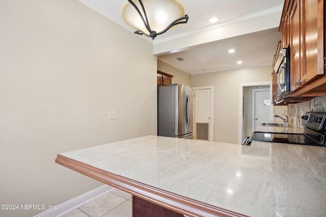 kitchen featuring appliances with stainless steel finishes, tasteful backsplash, crown molding, and light tile patterned flooring