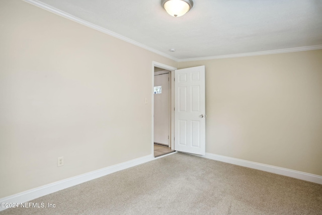 unfurnished room with light carpet and crown molding