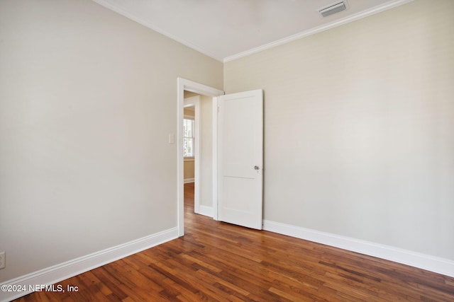 empty room with hardwood / wood-style floors and ornamental molding