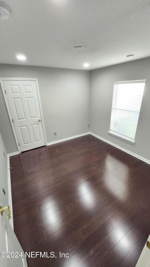 unfurnished room featuring dark hardwood / wood-style flooring