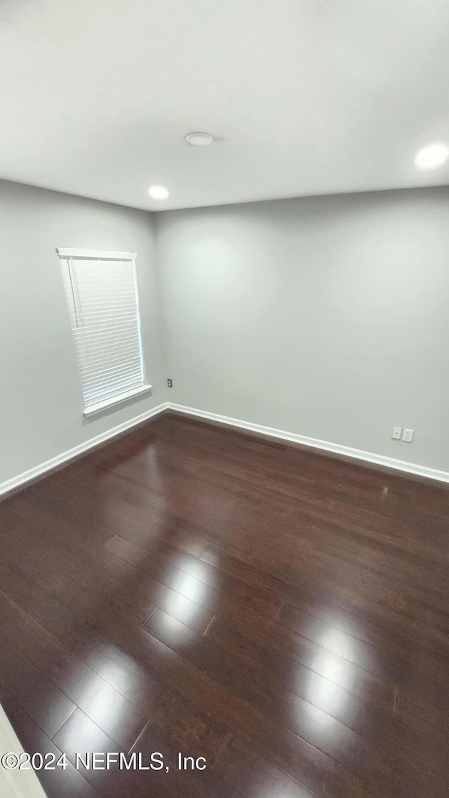 spare room featuring wood-type flooring