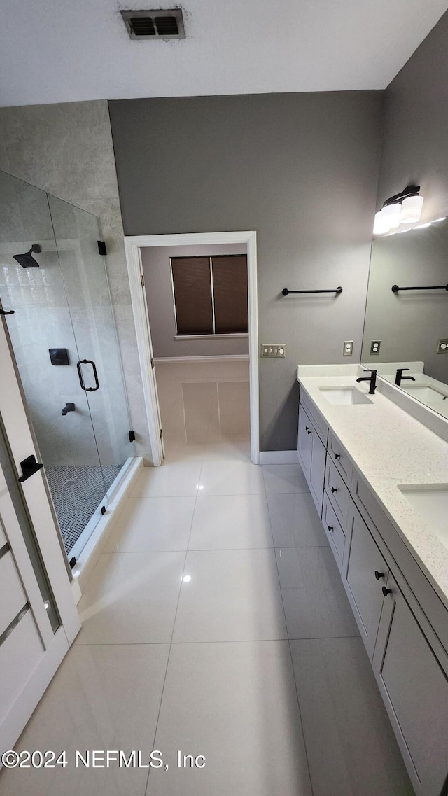 bathroom with vanity, tile patterned floors, and walk in shower