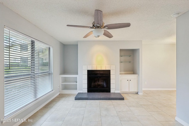 unfurnished living room with light tile patterned floors, a textured ceiling, built in features, and ceiling fan