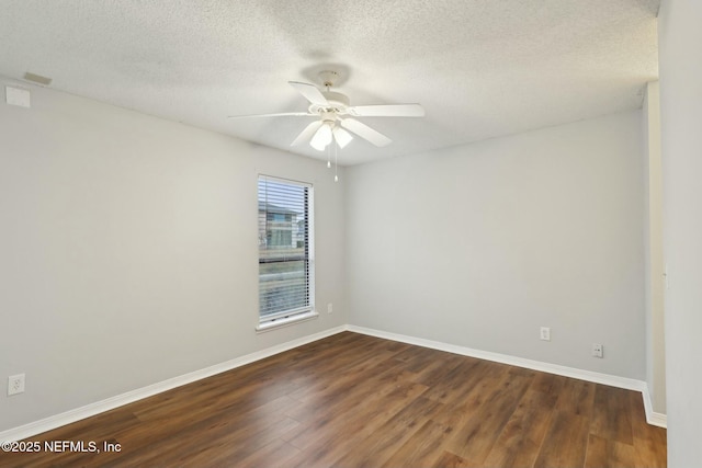 unfurnished room featuring ceiling fan, dark wood-type flooring, and a textured ceiling