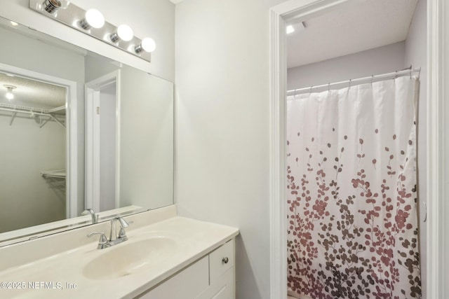 bathroom featuring vanity and a shower with shower curtain