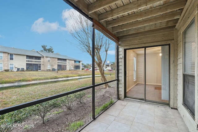 unfurnished sunroom featuring wood ceiling and beam ceiling