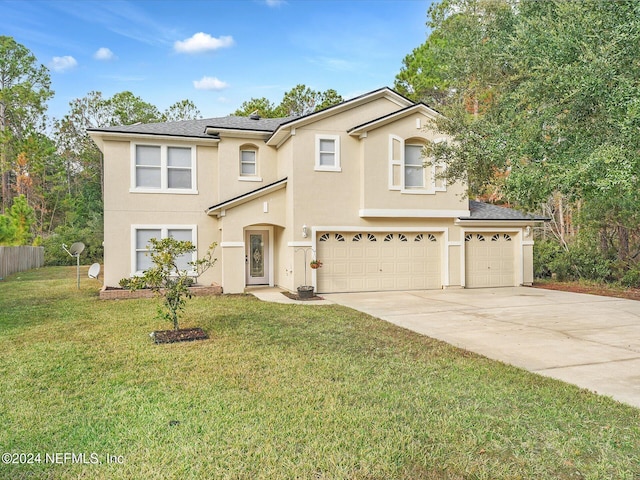 view of front of property featuring a front lawn and a garage