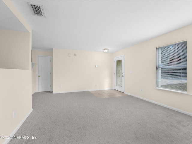 unfurnished room with light colored carpet