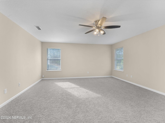 empty room featuring carpet flooring and ceiling fan