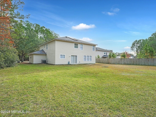 rear view of house with a lawn