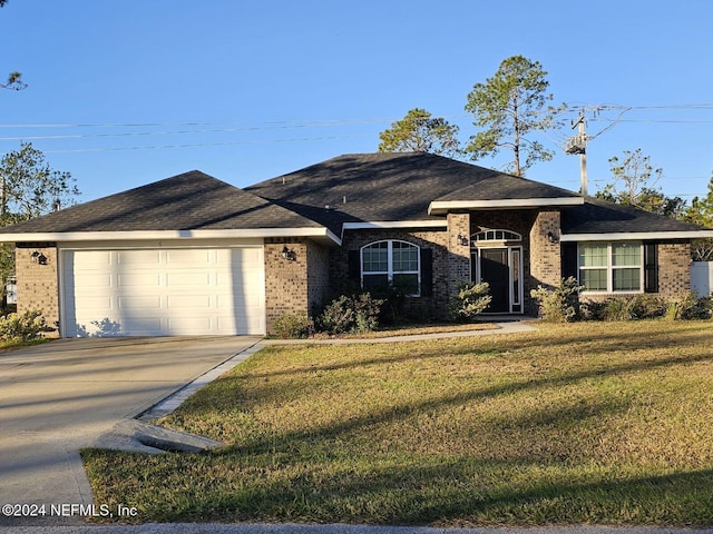 ranch-style home featuring a garage and a front lawn