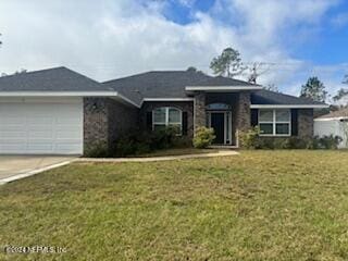 view of front of home with a garage and a front lawn