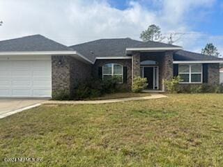 view of front of house with a garage and a front yard