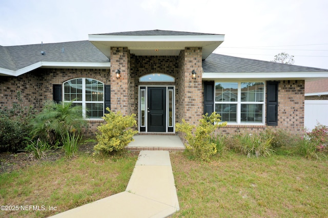 doorway to property featuring a yard