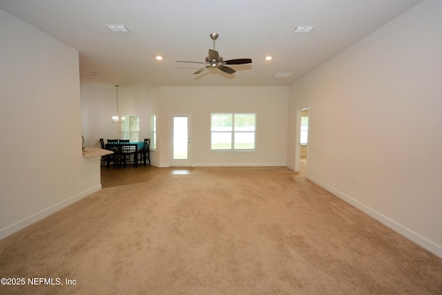 unfurnished living room featuring light carpet and ceiling fan