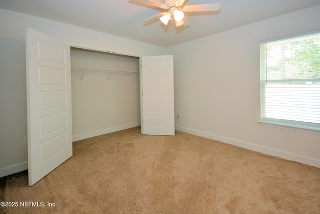 unfurnished bedroom featuring light carpet and a closet