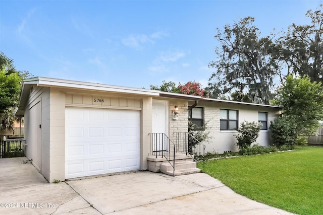 ranch-style house with a front yard and a garage