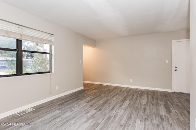 empty room with hardwood / wood-style floors