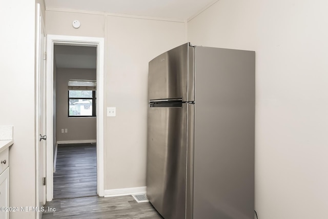 kitchen with stainless steel fridge and dark wood-type flooring