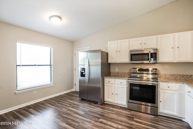 kitchen featuring dark hardwood / wood-style flooring, stainless steel appliances, white cabinetry, and lofted ceiling