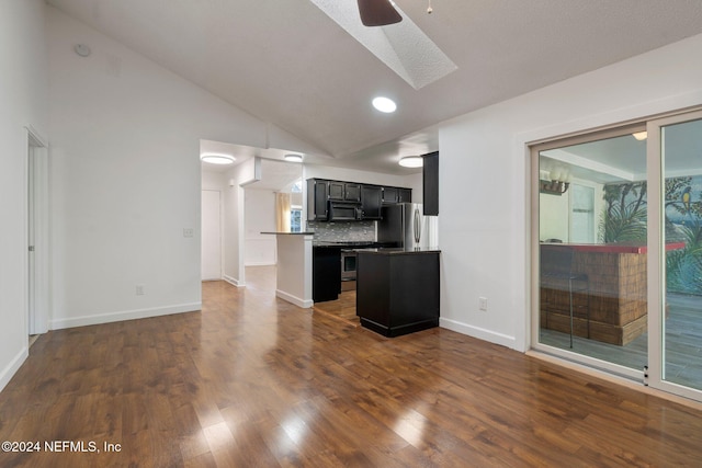 kitchen featuring lofted ceiling, backsplash, ceiling fan, dark hardwood / wood-style flooring, and stainless steel appliances