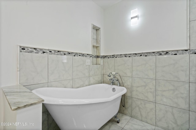 bathroom with a tub to relax in and tile walls