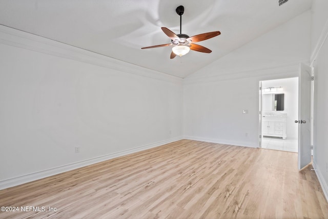 spare room with light wood-type flooring, high vaulted ceiling, and ceiling fan