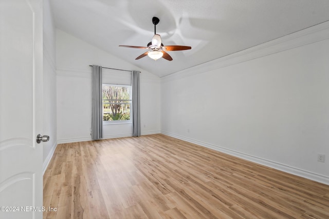 spare room featuring ceiling fan, crown molding, light hardwood / wood-style floors, and vaulted ceiling