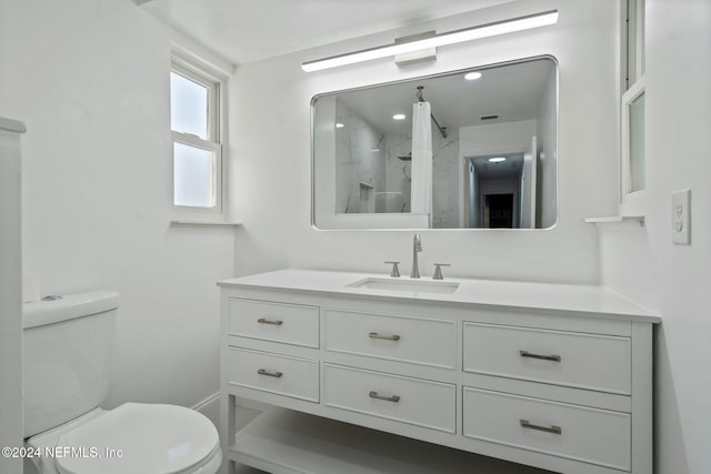 bathroom with vanity, an enclosed shower, and toilet