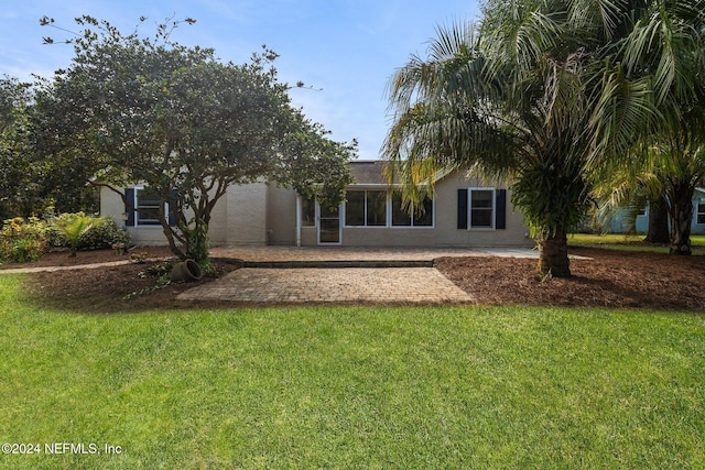 rear view of house with a lawn