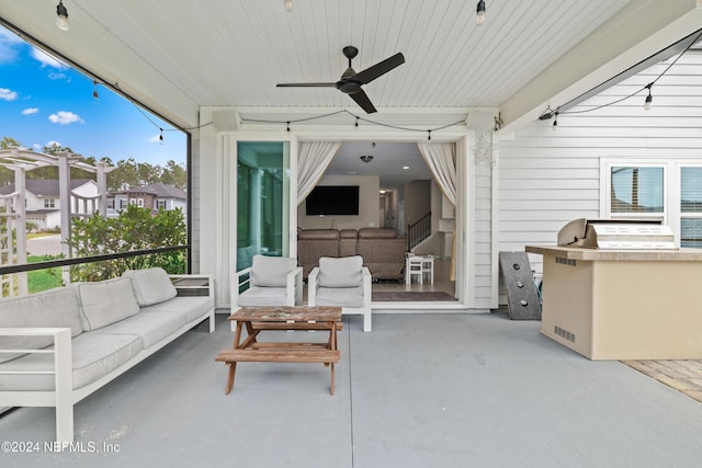 view of patio with outdoor lounge area, ceiling fan, and an outdoor kitchen