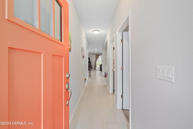 hallway with light tile patterned floors