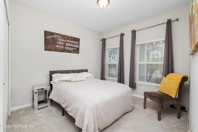 bedroom featuring light carpet