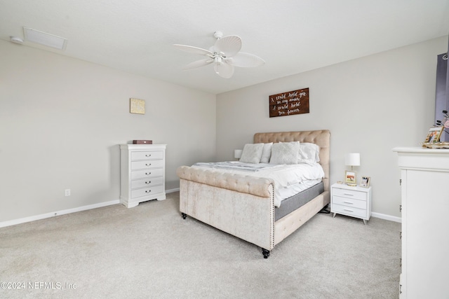 bedroom with ceiling fan and light carpet