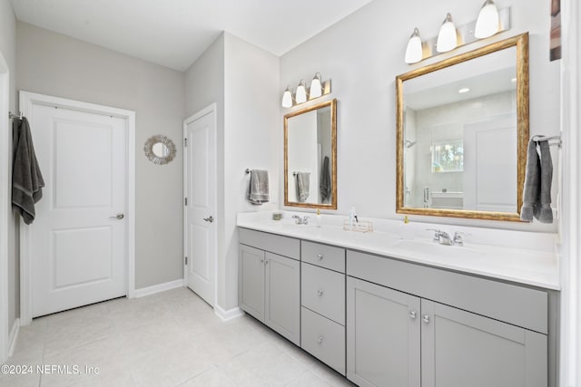 bathroom featuring tile patterned flooring, vanity, and a shower with door