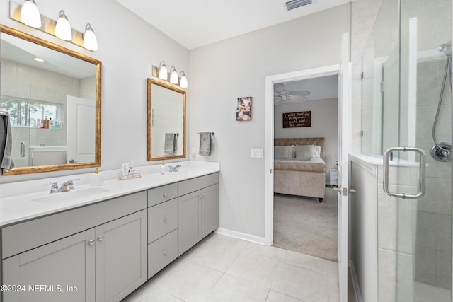 bathroom featuring tile patterned floors, vanity, ceiling fan, and a shower with shower door