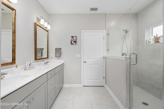 bathroom featuring vanity, tile patterned floors, and an enclosed shower